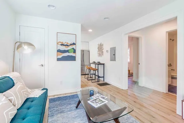 a living room with furniture and wooden floor