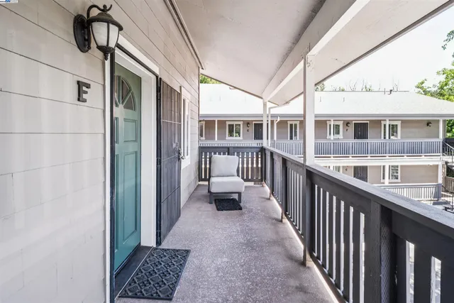 a view of a balcony with furniture