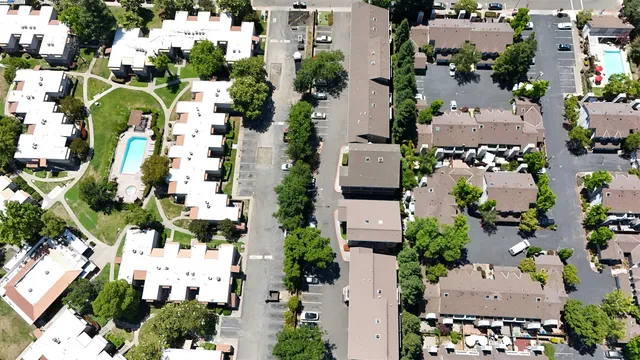 an aerial view of residential houses with outdoor space