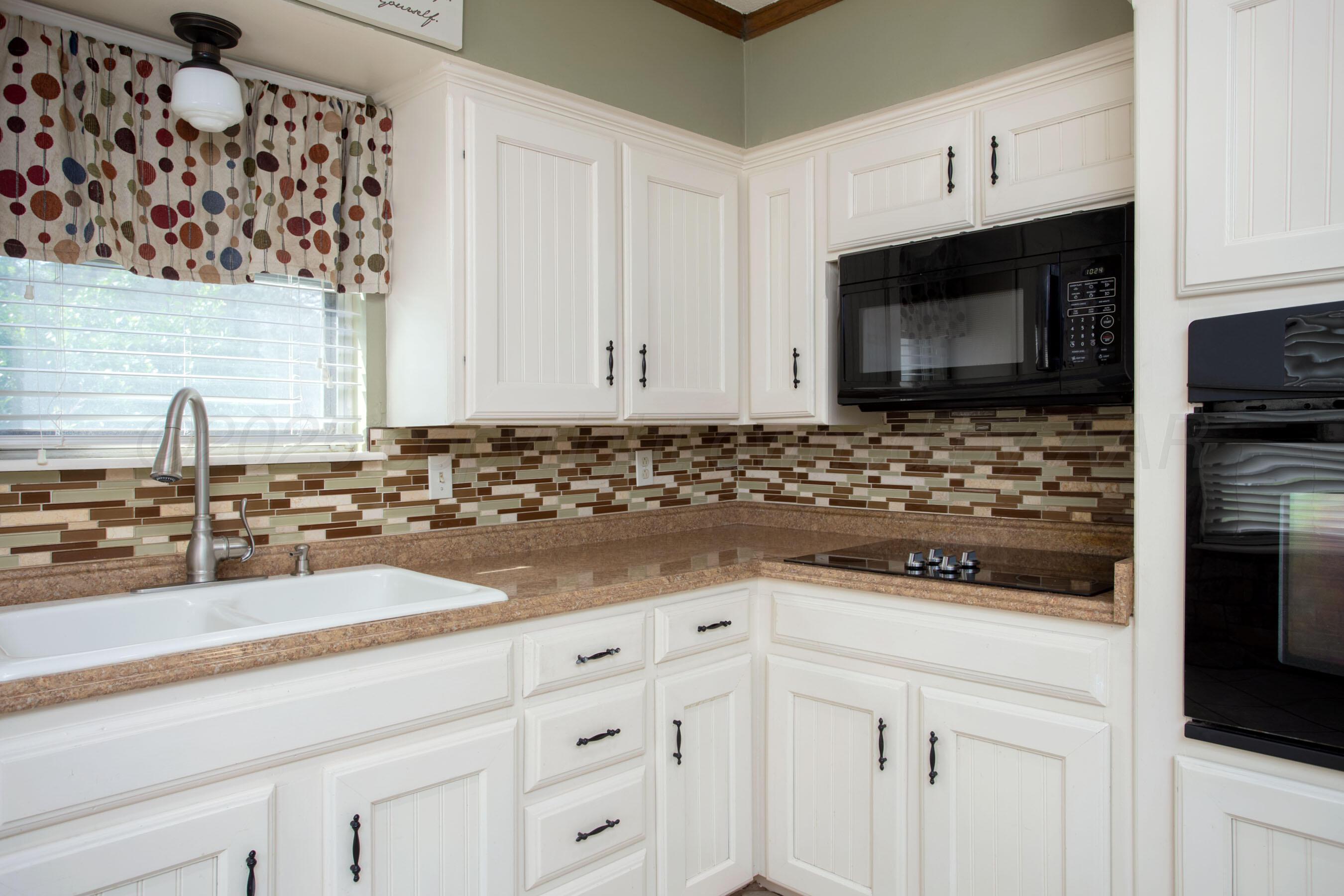 3729 Wayne Street Amarillo, TX 79109 - Photo 14 of 30 a kitchen with granite countertop white cabinets and stainless steel appliances