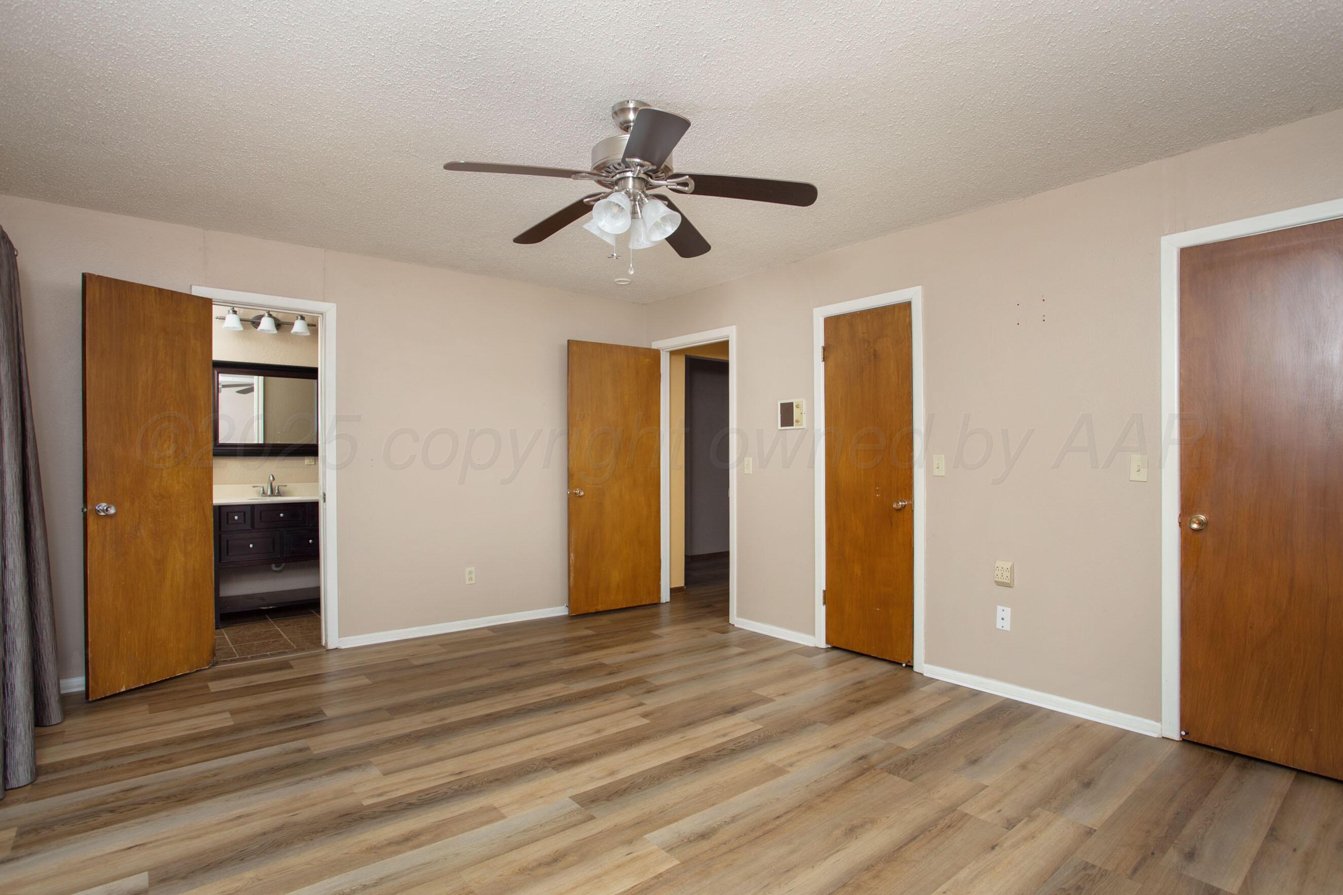 3729 Wayne Street Amarillo, TX 79109 - Photo 17 of 30 a view of empty room with wooden floor and ceiling fan