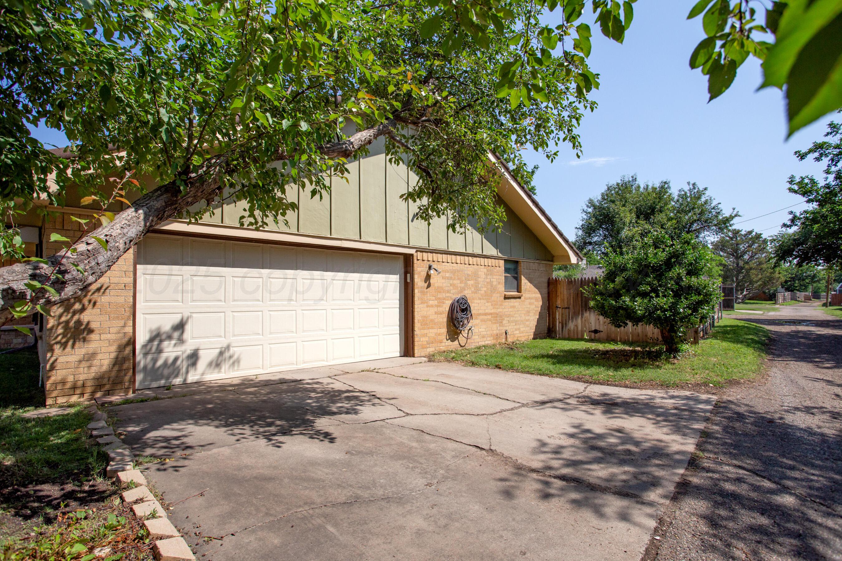 3729 Wayne Street Amarillo, TX 79109 - Photo 27 of 30 a front view of a house with a yard and garage