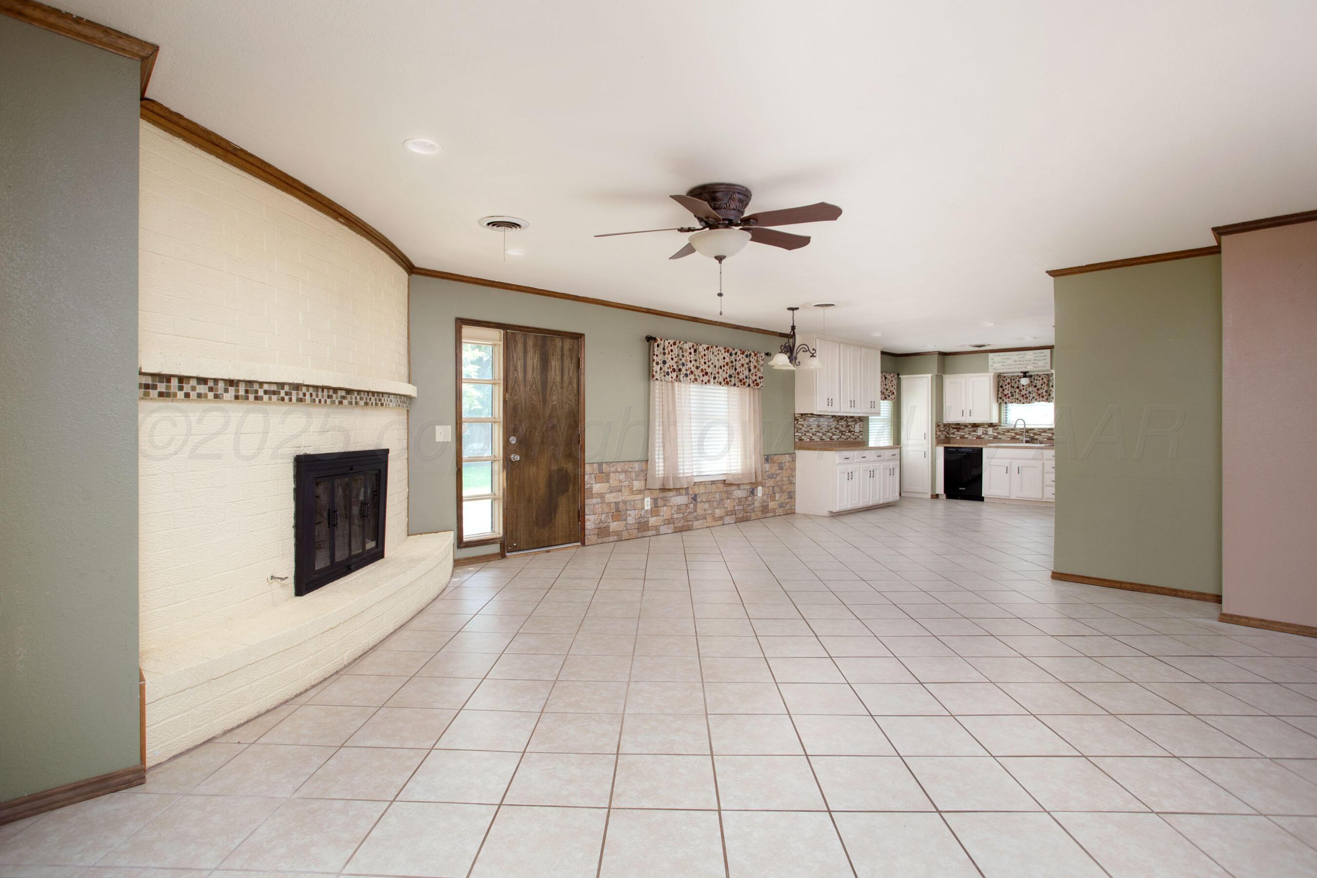 3729 Wayne Street Amarillo, TX 79109 - Photo 9 of 30 a view of a livingroom with a fireplace and window