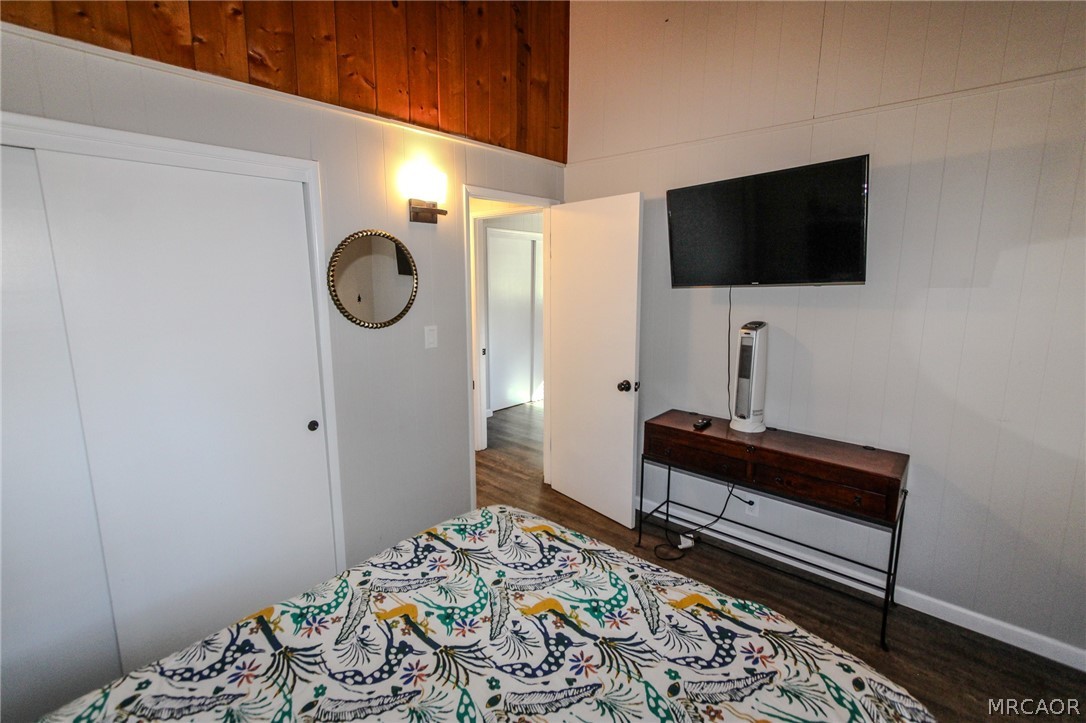 42830 Cougar Road, Unit UPPR Big Bear Lake, CA 92315 - Photo 14 of 21 a bedroom with a bed and a flat screen tv