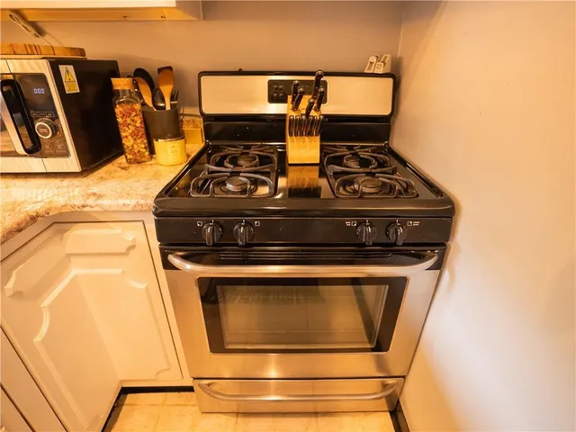 a stove top oven sitting inside of a kitchen