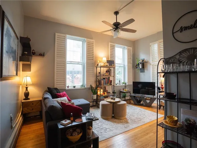 a living room with furniture fireplace and a window