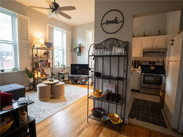 a living room with furniture a window and kitchen view