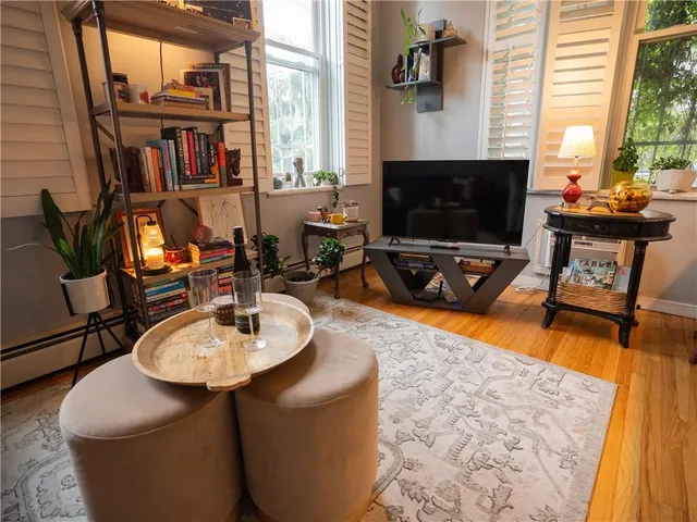a living room with fireplace furniture and a flat screen tv