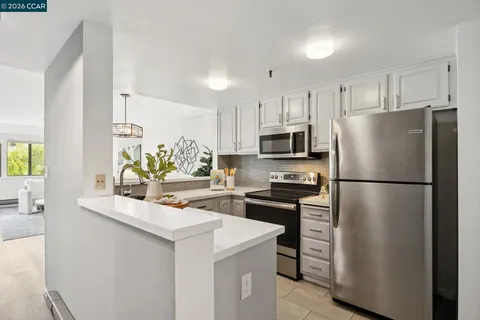 a kitchen with stainless steel appliances a refrigerator stove microwave and sink