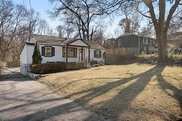 a front view of a house with a yard covered in snow