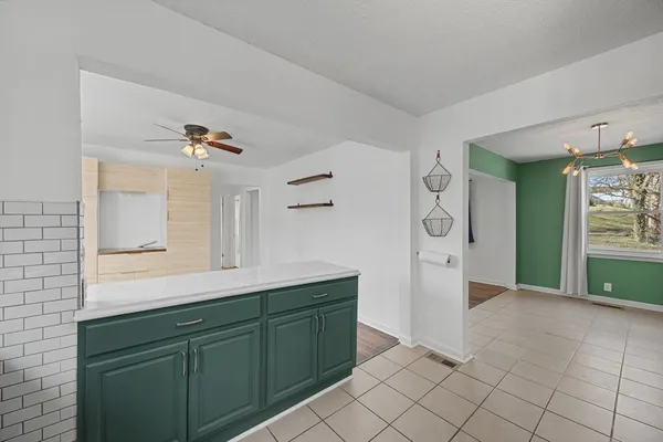 a kitchen with a sink a refrigerator and cabinets