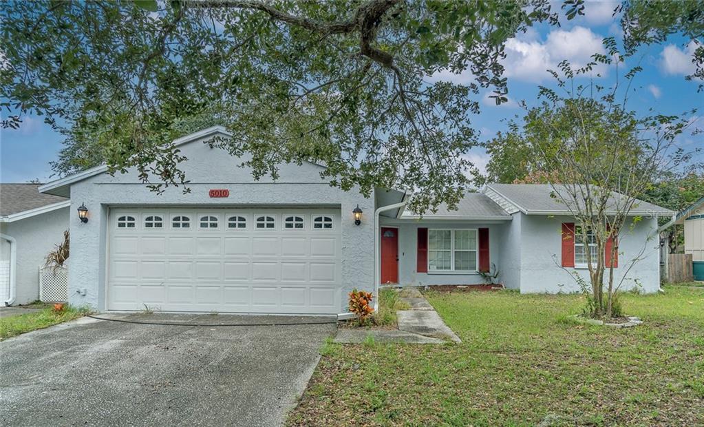 5010 Larch Lane New Port Richey, FL 34653 - Photo 1 of 1 a front view of a house with garden
