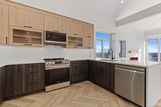 a kitchen with stainless steel appliances granite countertop a stove and a microwave