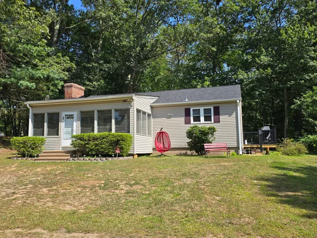 a front view of house with yard and green space