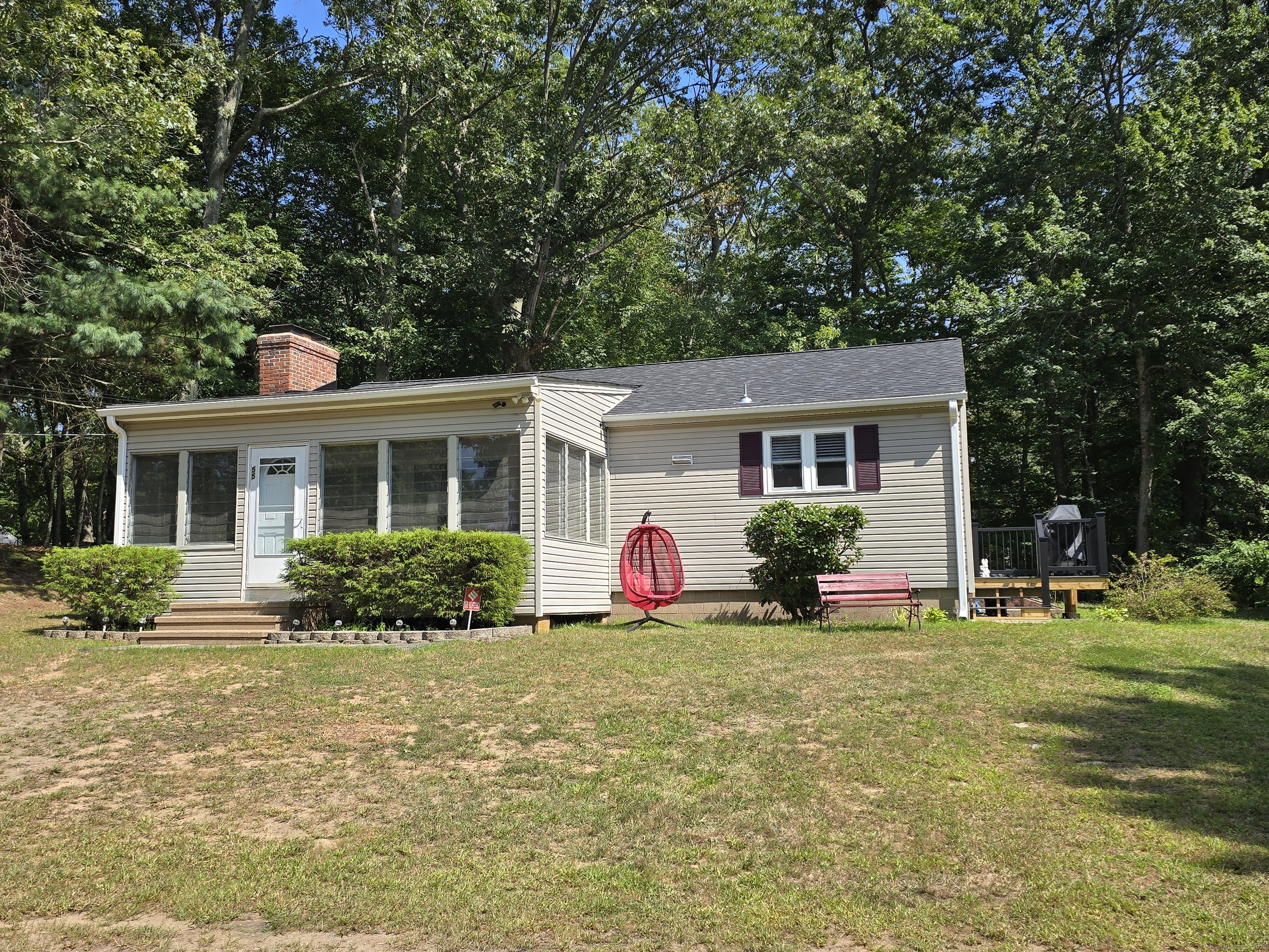 a front view of house with yard and green space