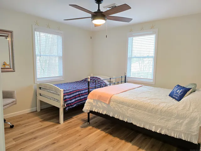 a bedroom with a bed and window