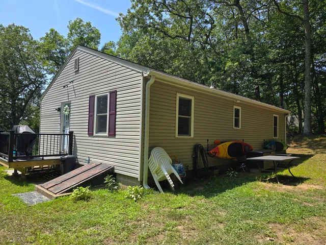 a backyard of a house with yard and outdoor seating