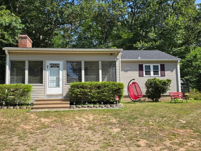 a front view of house with yard and green space