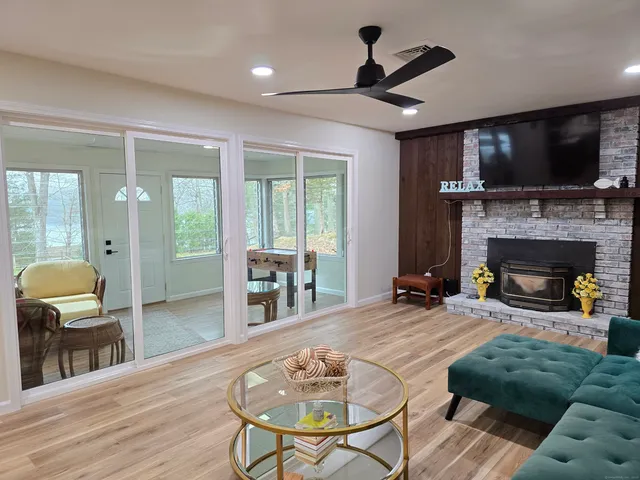 a living room with furniture a flat screen tv and a fireplace