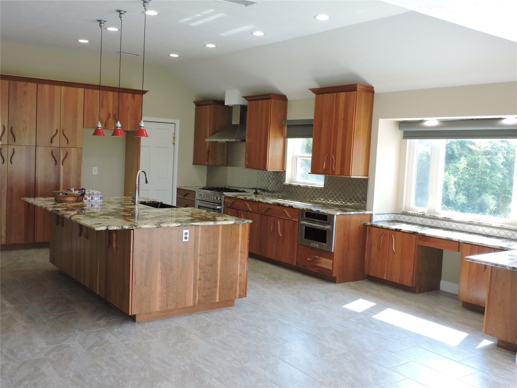 25730 Beckendorff Road Katy, TX 77493 - Photo 16 of 42 a large kitchen with stainless steel appliances granite countertop a stove a sink and a refrigerator