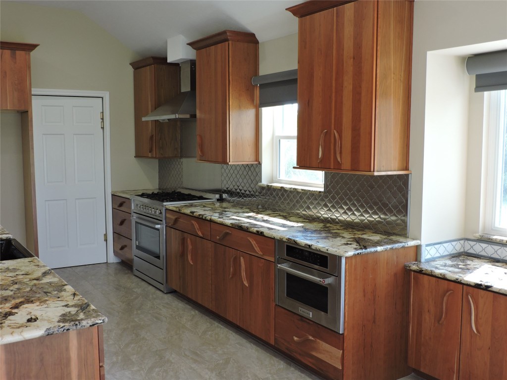 25730 Beckendorff Road Katy, TX 77493 - Photo 17 of 42 a kitchen with granite countertop a stove and a refrigerator
