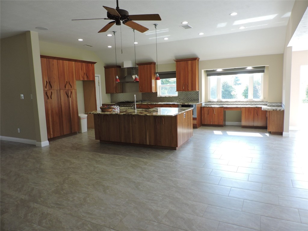 25730 Beckendorff Road Katy, TX 77493 - Photo 20 of 42 a kitchen with stainless steel appliances granite countertop a lot of cabinets and wooden floor