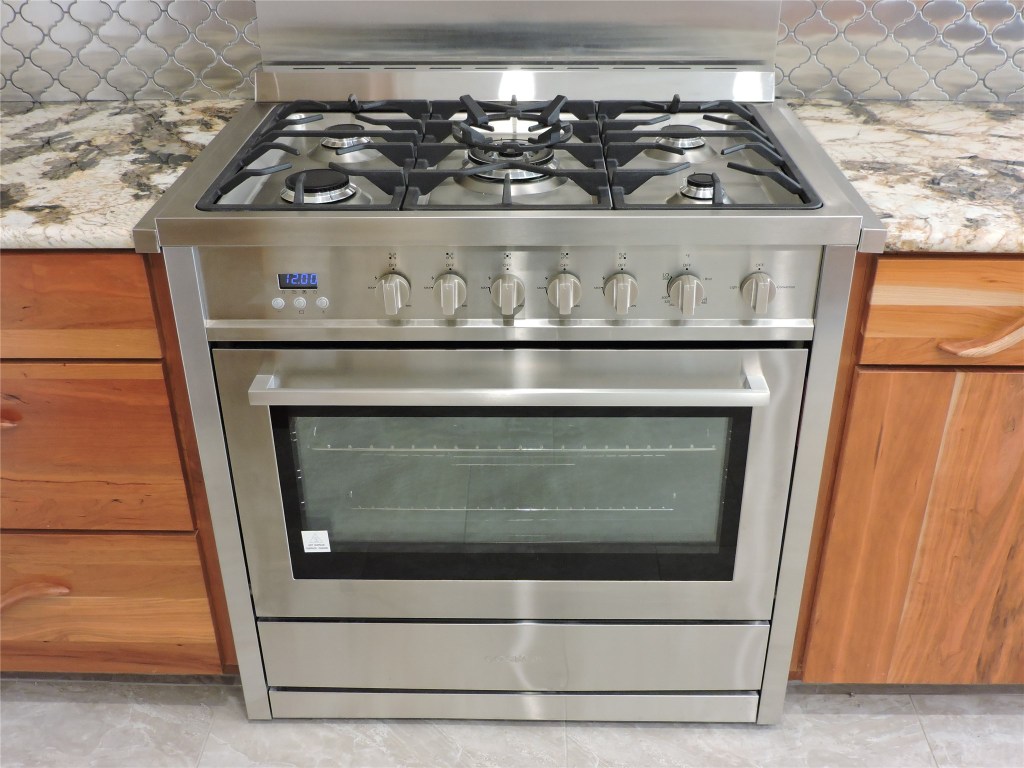 25730 Beckendorff Road Katy, TX 77493 - Photo 21 of 42 a stove top oven sitting inside of a kitchen
