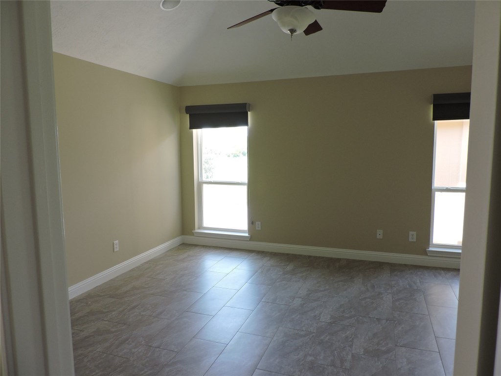 25730 Beckendorff Road Katy, TX 77493 - Photo 28 of 42 an empty room with wooden floor and windows