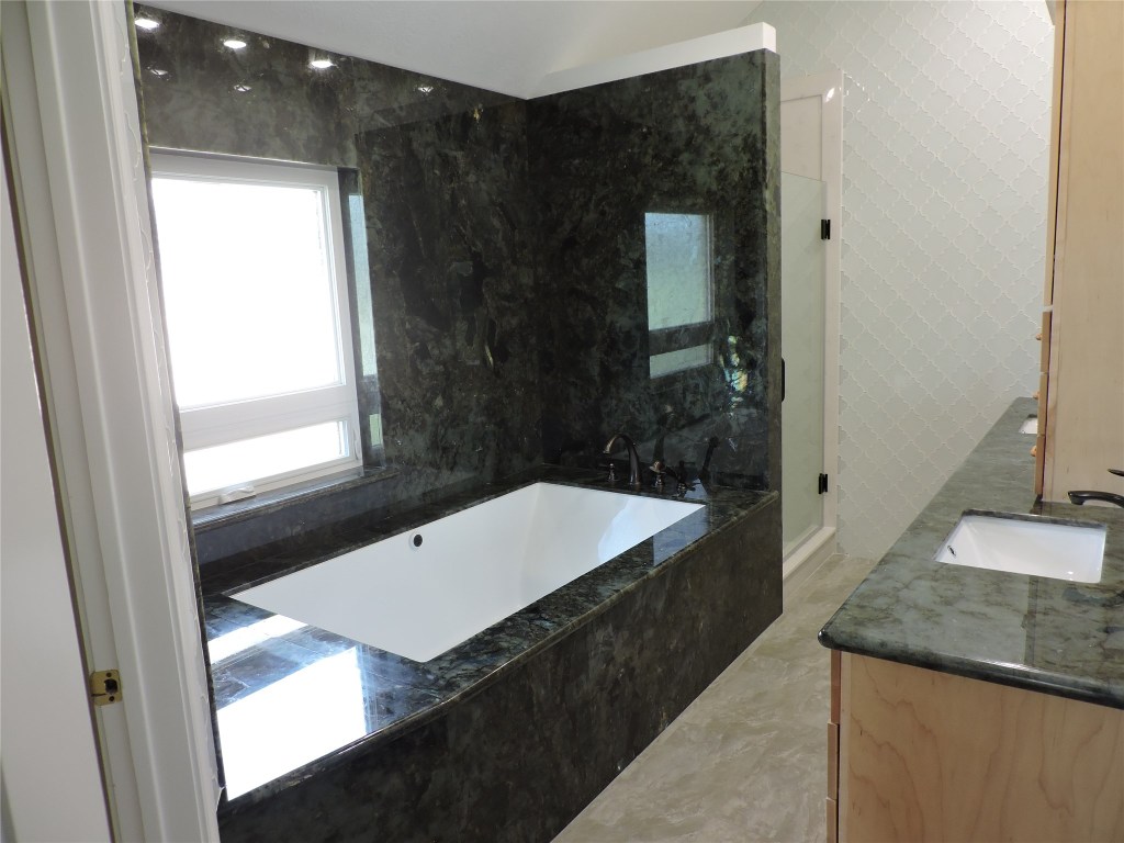 25730 Beckendorff Road Katy, TX 77493 - Photo 30 of 42 a bathroom with a granite countertop sink and mirror