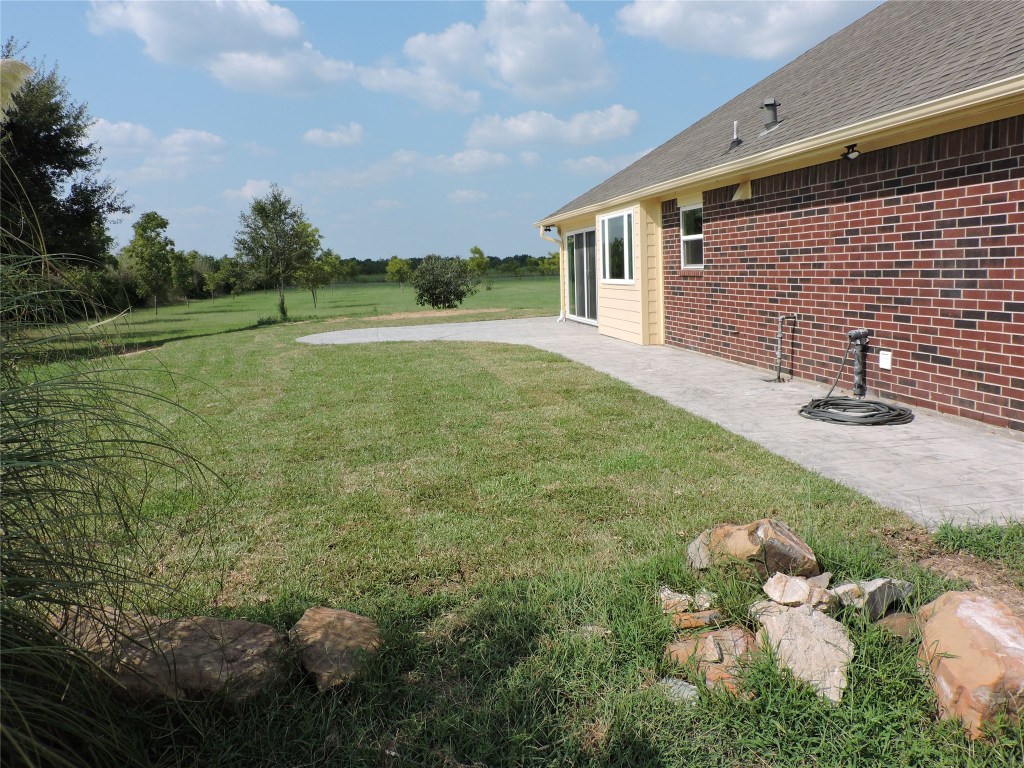 25730 Beckendorff Road Katy, TX 77493 - Photo 7 of 42 a backyard of a house with lots of green space