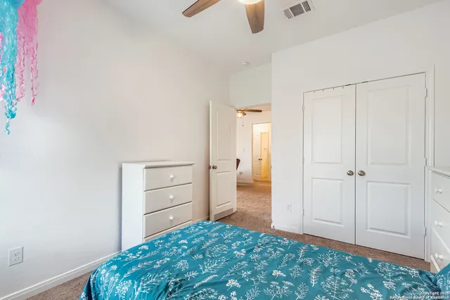 a bedroom with a bed and cabinets