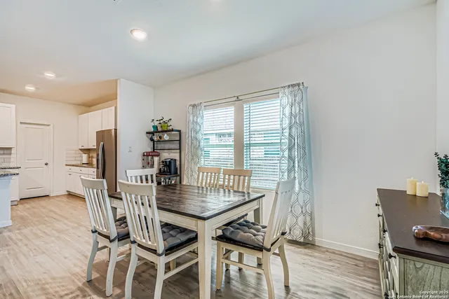 a dining room with furniture and wooden floor