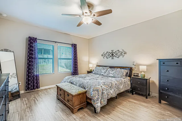 a bedroom with a bed chandelier and a window