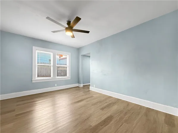 a view of empty room with wooden floor