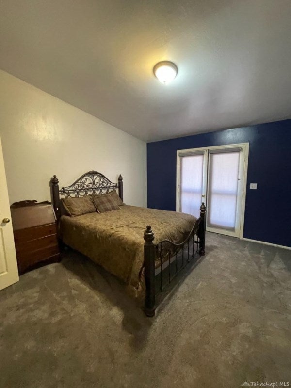 18451 Arosa Road Tehachapi, CA 93561 - Photo 30 of 56 main bedroom has exit to back yard area. newer carpet