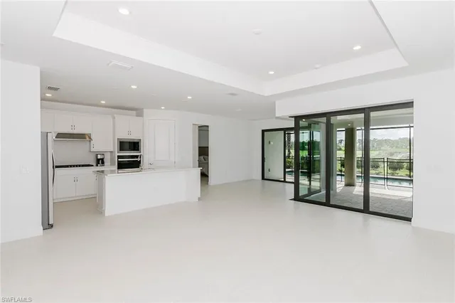 a view of kitchen with furniture and refrigerator