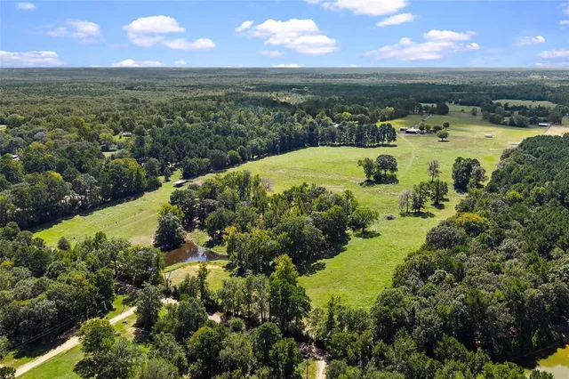 a view of a field with an trees in the background