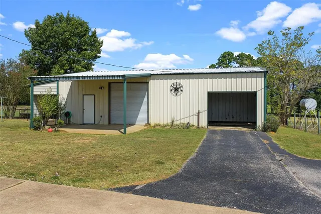 a view of a house with a yard and garage