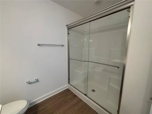 a bathroom with a glass shower door