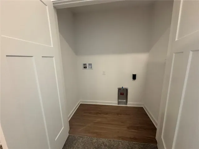 a view of a room with wooden floor and a window