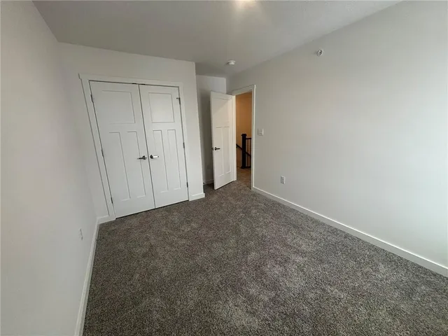 a view of an empty room and closet area