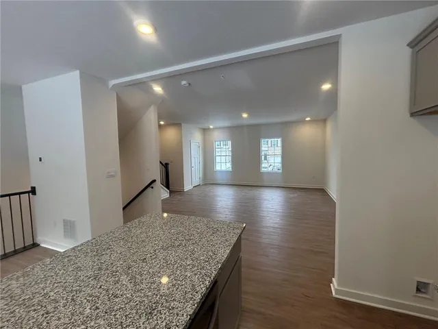 a view of kitchen and hall with wooden floor