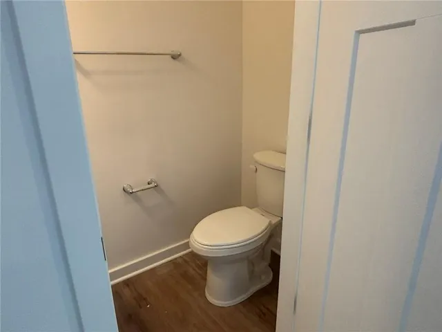 a white toilet sitting in a bathroom