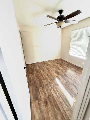 a view of a room with a ceiling fan