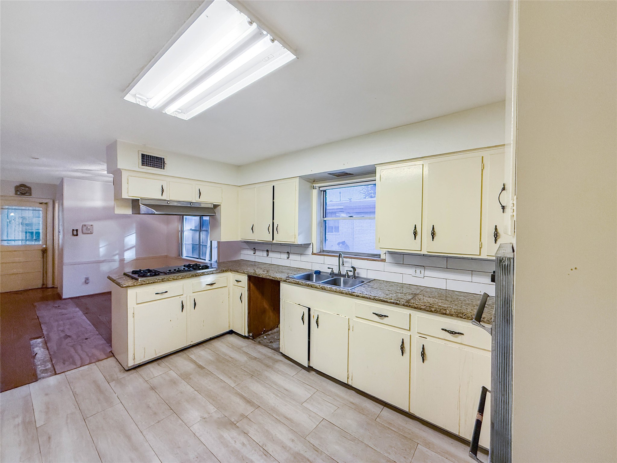 8219 Colgate Street Houston, TX 77061 - Photo 12 of 39 a kitchen with a sink stove top oven and cabinets