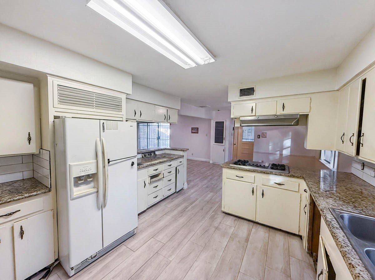 8219 Colgate Street Houston, TX 77061 - Photo 13 of 39 a kitchen with a stove a refrigerator and a sink