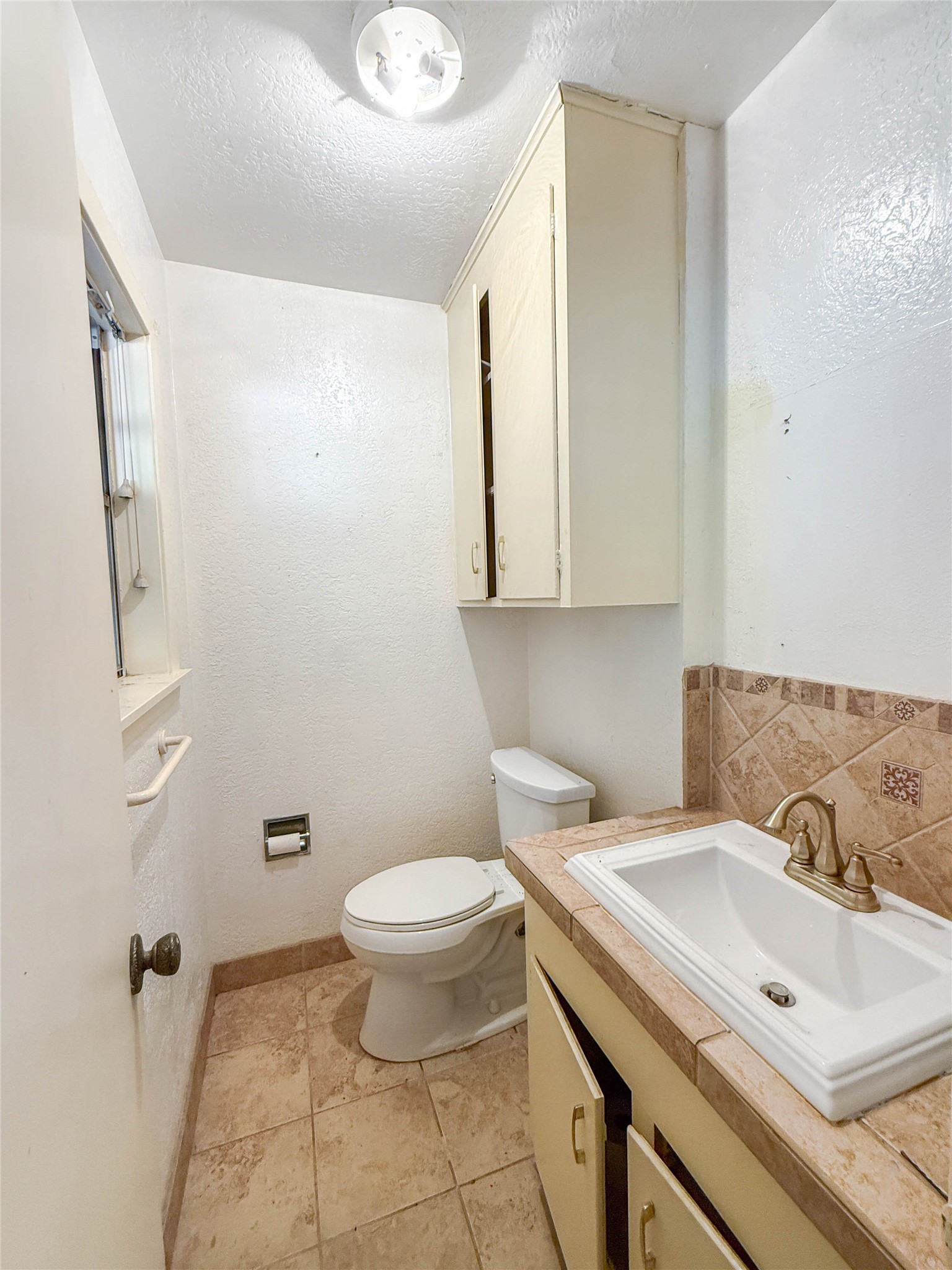 8219 Colgate Street Houston, TX 77061 - Photo 15 of 39 a bathroom with a sink and a toilet