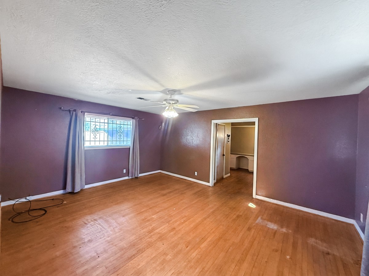 8219 Colgate Street Houston, TX 77061 - Photo 16 of 39 an empty room with wooden floor and windows