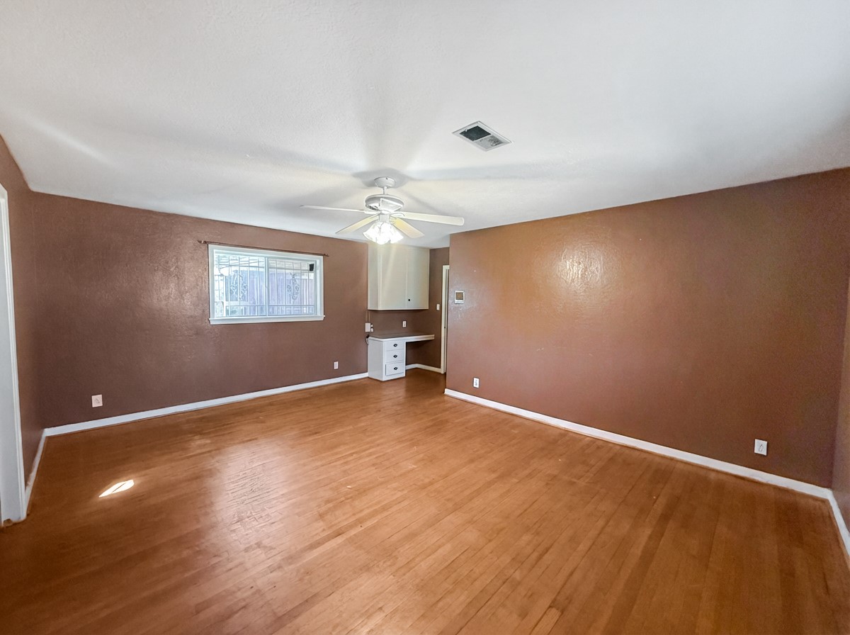 8219 Colgate Street Houston, TX 77061 - Photo 17 of 39 a view of an empty room with wooden floor and a window