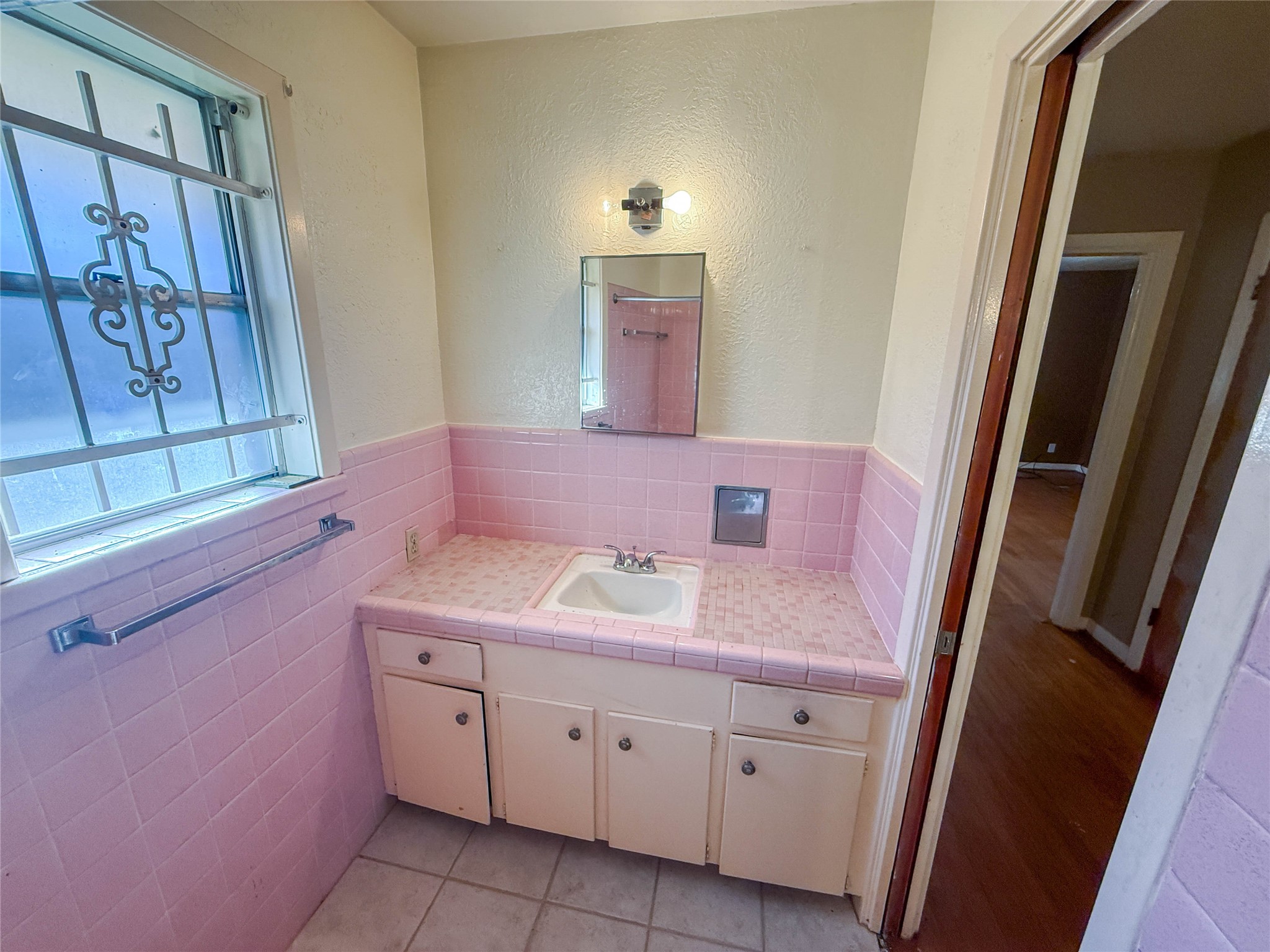 8219 Colgate Street Houston, TX 77061 - Photo 23 of 39 a bathroom with a sink and a mirror